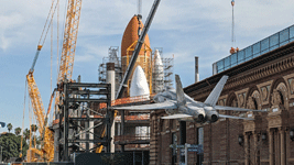 With the retired F/A-18 Hornet in the foreground, Endeavour's Space Shuttle Stack is fully assembled at the construction site for the future Samuel Oschin Air and Space Center in Los Angeles...on January 30, 2024.