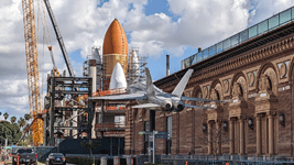 With the retired F/A-18 Hornet in the foreground, Endeavour's completed Space Shuttle Stack stands tall at the construction site for the Samuel Oschin Air and Space Center...on February 2, 2024.