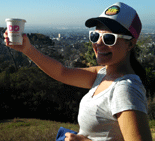 Nidal poses with her coffee cup during a hike.