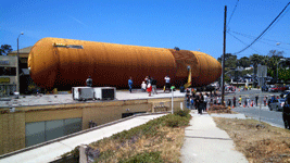 Onlookers gather on a rooftop to take photos of ET-94 as it rolls down Manchester Boulevard in Inglewood...on May 21, 2016.