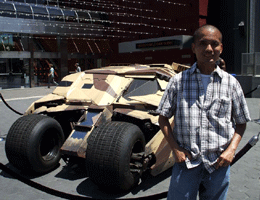 Posing in front of the Tumbler from THE DARK KNIGHT RISES outside of the AMC Citywalk theater in Hollywood, on July 20, 2012.