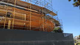 Scaffolding surrounds ET-94 at its temporary location outside the Samuel Oschin Pavilion...on August 17, 2023.