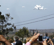 Followed by two F-18 chase planes, the Shuttle Carrier Aircraft ferrying Endeavour flies over LAX on September 21, 2012.