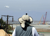 Followed by two F-18 chase planes, the Shuttle Carrier Aircraft ferrying Endeavour flies over LAX on September 21, 2012.