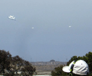 Followed by two F-18 chase planes, the Shuttle Carrier Aircraft ferrying Endeavour flies over LAX on September 21, 2012.