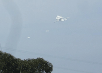 Followed by two F-18 chase planes, the Shuttle Carrier Aircraft ferrying Endeavour flies over LAX on September 21, 2012.