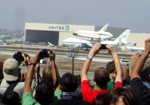 The Shuttle Carrier Aircraft carrying Endeavour heads for a United Airlines hangar at LAX on September 21, 2012.