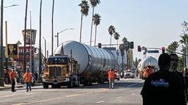 Trucks towing Endeavour's two solid rocket motors begin driving down Figueroa Street to the California Science Center in Exposition Park...on October 11, 2023.