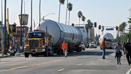 Trucks towing Endeavour's two solid rocket motors begin driving down Figueroa Street to the California Science Center in Exposition Park...on October 11, 2023.