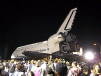 Space shuttle Endeavour looks like she is floating on the crowd at the Baldwin Hills Crenshaw Plaza, on October 13, 2012.