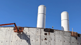 The twin solid rocket motors for Endeavour stand tall at the construction site for the future Samuel Oschin Air and Space Center in Los Angeles...on November 8, 2023.