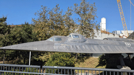 With the retired A-12 Blackbird in the foreground, the twin solid rocket motors for Endeavour stand tall at the construction site for the future Samuel Oschin Air and Space Center in Los Angeles...on November 8, 2023.