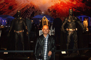 Posing with the Batsuits of THE DARK KNIGHT Trilogy, on December 7, 2012.