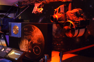 The Voyager Golden Record and a close-up of the spacecraft's imaging system.