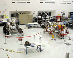 The Curiosity rover and its descent stage on display inside the Spacecraft Assembly Facility.