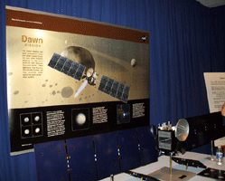 A portrait and model of the Dawn spacecraft, which will arrive at asteroid Vesta in July of this year and dwarf planet Ceres in 2015.