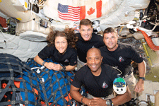 The Artemis II astronauts and Rise, their zero-gravity indicator, pose for a group photo inside the Orion capsule on April 7, 2026