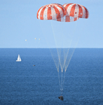 With its three main parachutes deployed, the Orion capsule is about to splash down into the Pacific Ocean to conclude the Artemis II mission, on April 10, 2026