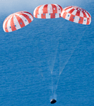 With its three main parachutes deployed, the Orion spacecraft is about to splash down into the Pacific Ocean to conclude the Artemis I mission, on December 11, 2022