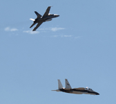 Two NASA aircraft - an F-15 Eagle and F/A-18D Hornet - conduct an aerial demo during the Aerospace Valley Air Show at Edwards Air Force Base, California...on October 15, 2022.