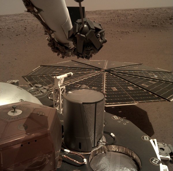 One of InSight's twin solar panels and its flight deck are visible in this image taken by a camera on the spacecraft's robotic arm...on December 7, 2018