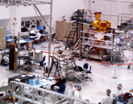 Clad in bunny suits, engineers work on the SMAP satellite inside the SAF clean room at NASA JPL...on September 8, 2014.