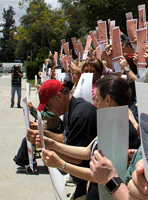 Holding Spirit Mars panorama posters as the JPL Tweetup group photo is taken.