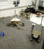 Engineering models of Mars rovers inside the In-Situ Instrument Laboratory.
