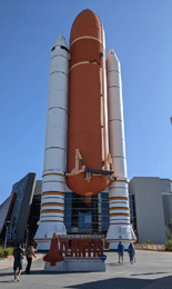 Full-size replicas of an External Tank and twin Solid Rocket Boosters outside the Space Shuttle Atlantis Exhibit.