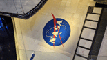A snapshot of Atlantis' port-side wing and the 'NASA Meatball' logo.