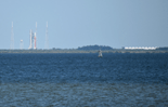 The Space Launch System rocket and Apollo/Saturn V Center as seen from across the Indian River.