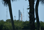 The Space Launch System beyond the palm trees.