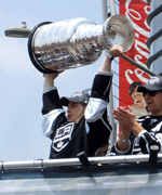 Team captain Dustin Brown hoists up the Stanley Cup trophy during the Los Angeles Kings' 2012 championship parade