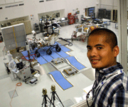 Posing with the Curiosity Mars rover and her descent stage behind me, at NASA's Jet Propulsion Laboratory on June 6, 2011