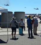 Onlookers watch as two V-22 Osprey tilt-rotor aircraft fly over the field at Miramar MCAS...on September 24, 2016.