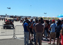 Onlookers watch as two V-22 Ospreys fly over the airfield at Miramar MCAS...on September 24, 2016.