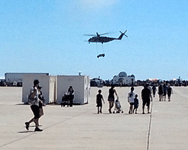 Onlookers watch as an MH-53 Pave Low helicoper ferries a Humvee during a combat demo at Miramar MCAS...on September 24, 2016.
