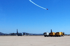 An air demo takes place above the parked C-130 at Miramar MCAS...on September 24, 2016.