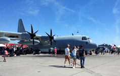 People gather underneath the C-130 to take shade from the sun at Miramar MCAS...on September 24, 2016.