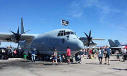 People gather underneath the C-130 to take shade from the sun at Miramar MCAS...on September 24, 2016.