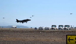 An AV-8B Harrier takes to the air while UH-1Y Venom helicopters and AH-1 Cobra attack choppers fly behind it...on September 29, 2018.