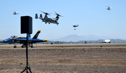 A V-22 Osprey flies over the MCAS Miramar runway with a CH-53 Sea Stallion hauling a Humvee in mid-air behind it...on September 29, 2018.