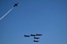 The Patriots Jet Team performs the missing man formation to honor the fallen air show pilot.