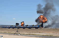 Fireballs erupt behind the Blue Angels during the Marine Air-Ground Task Force (MAGTF) demo at the Miramar Air Show in San Diego, California...on September 24, 2022.