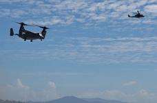 A V-22 Osprey takes to the sky as a UH-1 Iroquois flies nearby during the MAGTF demo...at the Miramar Air Show on September 24, 2022.