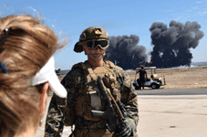 A Marine soldier walks by as explosions erupt on the airfield during the MAGTF demo at the Miramar Air Show...on September 24, 2022.