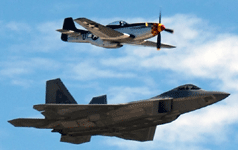 The F-22 Raptor and a World War II-era P-51 Mustang fly in unison during a U.S. Air Force Heritage Flight demo at the Miramar Air Show...on September 24, 2022.