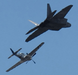 The F-22 Raptor and P-51 Mustang fly in unison during a U.S. Air Force Heritage Flight demo at the Miramar Air Show...on September 24, 2022.