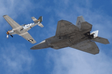 The F-22 Raptor and P-51 Mustang fly in unison during a U.S. Air Force Heritage Flight demo at the Miramar Air Show...on September 24, 2022.