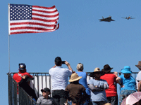 The F-22 Raptor and P-51 Mustang are about to fly over a grandstand at the Miramar Air Show...on September 24, 2022.